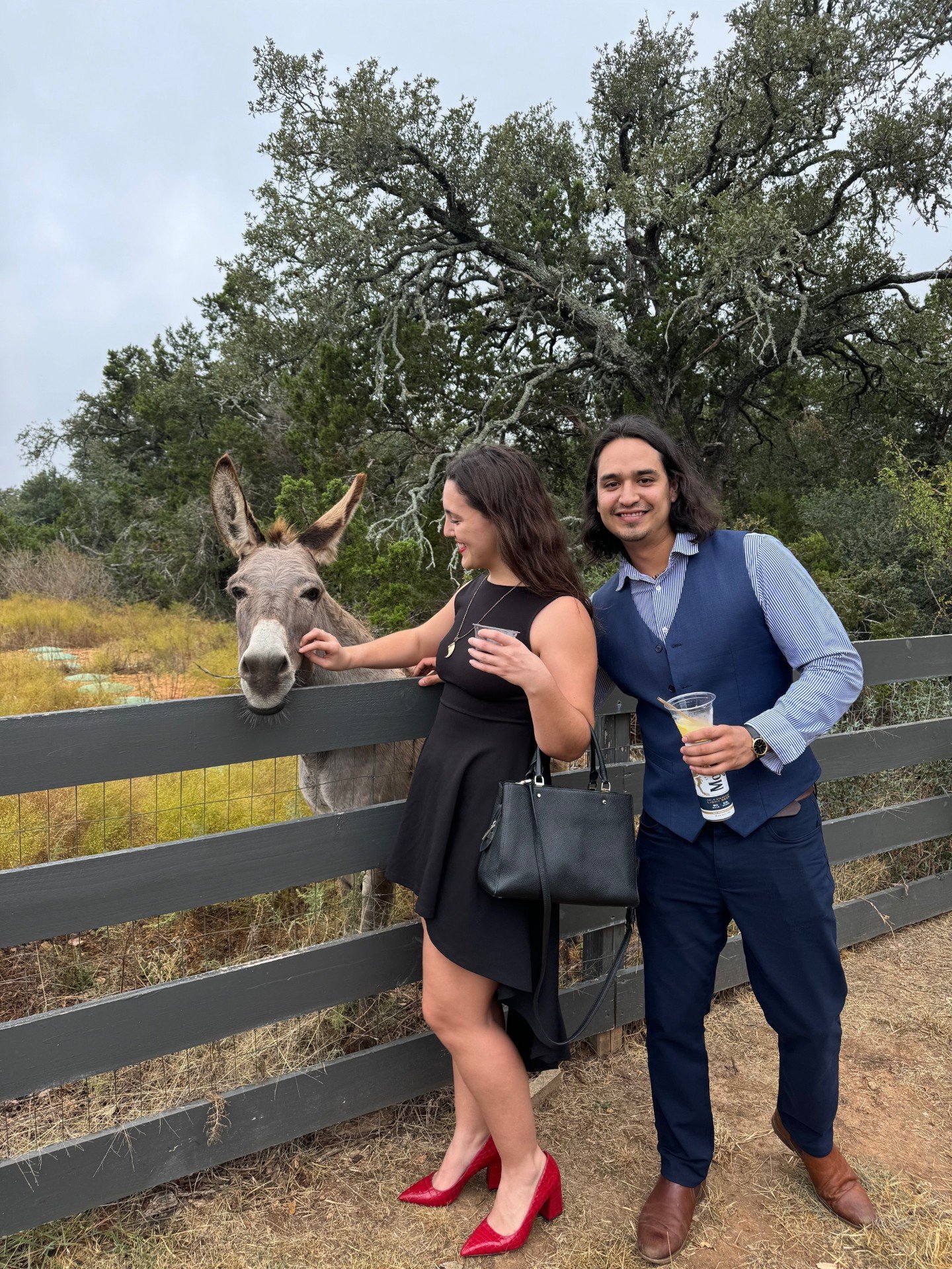 Wedding couple with friendly donkeys at Willow Sky Ranch Hill Country wedding venue